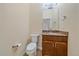 Powder bathroom features a granite countertop, toilet, and modern fixtures at 1130 Summit View Dr, Louisville, CO 80027