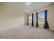 Spacious bedroom featuring neutral carpeting, two windows, and dark curtains at 1130 Summit View Dr, Louisville, CO 80027