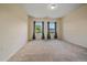 Bright bedroom features neutral carpeting, two windows, and blue curtains at 1130 Summit View Dr, Louisville, CO 80027