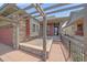 Inviting front porch with pergola and stone pillars at this home's entrance at 1130 Summit View Dr, Louisville, CO 80027