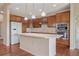 Bright kitchen features wood cabinets, stainless steel appliances, granite counters, and hardwood floors at 1130 Summit View Dr, Louisville, CO 80027