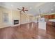 Open-concept living space with hardwood floors, a fireplace, and access to the kitchen area at 1130 Summit View Dr, Louisville, CO 80027