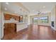 Spacious kitchen and living room with hardwood floors, granite countertops, and modern appliances at 1130 Summit View Dr, Louisville, CO 80027