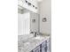 Contemporary bathroom featuring granite countertops, modern fixtures, and a large vanity mirror at 3328 S Danube St, Aurora, CO 80013