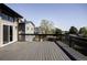 Wide-angle view of a spacious deck with dark wood finish and black railings with views of the neighborhood at 3328 S Danube St, Aurora, CO 80013
