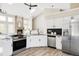 Open kitchen design featuring stainless appliances, granite counters, and adjacent dining space at 3328 S Danube St, Aurora, CO 80013