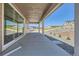Covered back porch with a large sliding glass door and gravel landscaping around the new home at 4748 Weitbrec Ln, Castle Rock, CO 80104