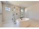 Modern bathroom featuring soaking tub and glass shower at 4748 Weitbrec Ln, Castle Rock, CO 80104