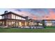 Stunning exterior elevation featuring a covered patio and scenic sunset backdrop at 4748 Weitbrec Ln, Castle Rock, CO 80104