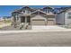 Beautiful two-story home featuring a two-car garage and stone accents, enhancing its curb appeal at 4748 Weitbrec Ln, Castle Rock, CO 80104
