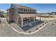 Exterior shot of the new home featuring a covered back porch, landscaping and view of the neighborhood at 4748 Weitbrec Ln, Castle Rock, CO 80104