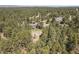 An aerial view shows the home nestled in a forest, offering privacy and serene natural surroundings at 35550 Running Brook Ln, Elizabeth, CO 80107