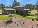 Expansive property showcasing a well-maintained home with a large deck, beautifully landscaped grounds, and surrounding trees at 35550 Running Brook Ln, Elizabeth, CO 80107