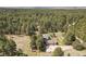 Expansive aerial view of a home nestled among dense trees, with a long driveway and ample outdoor space at 35550 Running Brook Ln, Elizabeth, CO 80107
