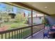 Covered back porch looking out over a landscaped yard, with hanging plants and decorative bird feeders at 35550 Running Brook Ln, Elizabeth, CO 80107