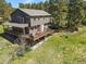 This is a backyard view with a large deck, seating, and well-maintained landscaping for outdoor enjoyment at 35550 Running Brook Ln, Elizabeth, CO 80107