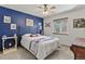 Comfortable bedroom with a decorative blue accent wall, light-colored carpet, and a window overlooking the yard at 35550 Running Brook Ln, Elizabeth, CO 80107