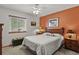 Cozy bedroom featuring a queen bed, complementary nightstands, bright windows, and an eye-catching accent wall at 35550 Running Brook Ln, Elizabeth, CO 80107