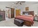 Spacious bedroom with a wooden bed frame, sliding barn door, and neutral carpet at 35550 Running Brook Ln, Elizabeth, CO 80107