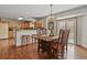 Inviting dining room featuring hardwood floors, a chandelier, and access to the outdoor space at 35550 Running Brook Ln, Elizabeth, CO 80107
