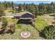 Aerial view of the exterior featuring a well-kept yard, fire pit, and spacious deck for outdoor living at 35550 Running Brook Ln, Elizabeth, CO 80107