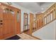 Welcoming foyer featuring hardwood flooring, a coat rack, and a staircase leading upstairs at 35550 Running Brook Ln, Elizabeth, CO 80107