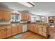 Well-lit kitchen with wooden cabinets and hardwood flooring, creating a warm and inviting atmosphere at 35550 Running Brook Ln, Elizabeth, CO 80107