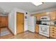 Efficient kitchen with hardwood floors, white appliances, and ample cabinet space at 35550 Running Brook Ln, Elizabeth, CO 80107