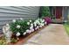 Charming front garden with lush peony bushes in pink and white, adding curb appeal to the home's exterior at 35550 Running Brook Ln, Elizabeth, CO 80107
