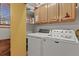 Practical laundry room with modern washer and dryer units, ample storage, and natural light at 35550 Running Brook Ln, Elizabeth, CO 80107