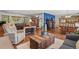 Bright living area flowing into the kitchen and dining space, showcasing hardwood floors and ample natural light at 35550 Running Brook Ln, Elizabeth, CO 80107