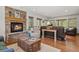 Inviting living room with a stone fireplace, comfortable seating, and hardwood floors, creating a warm ambiance at 35550 Running Brook Ln, Elizabeth, CO 80107