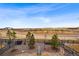 Spacious backyard with a scenic view, charming fence and a red bicycle accent at 1669 Stable View Dr, Castle Pines, CO 80108