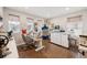 Bright sewing room with hardwood floors, multiple windows, sewing machines, and ample storage at 1669 Stable View Dr, Castle Pines, CO 80108