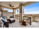 Relaxing deck area with comfortable seating and a beautiful view of the surrounding landscape at 1669 Stable View Dr, Castle Pines, CO 80108