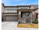 Inviting two-story home featuring a covered front porch and attached two-car garage at 1669 Stable View Dr, Castle Pines, CO 80108