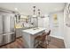 Beautiful kitchen featuring a quartz island, stainless steel refrigerator, and sliding door at 1669 Stable View Dr, Castle Pines, CO 80108