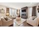 Cozy living room with a modern fireplace, plush seating, and large windows at 1669 Stable View Dr, Castle Pines, CO 80108