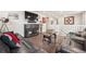 Open living room featuring hardwood floors, leather couches, and a large TV at 1669 Stable View Dr, Castle Pines, CO 80108