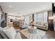 Spacious living room with open floor plan and view of the modern fireplace at 1669 Stable View Dr, Castle Pines, CO 80108