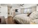 Bright main bedroom with hardwood floors, ceiling fan, and neutral decor at 1669 Stable View Dr, Castle Pines, CO 80108