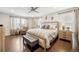 Bright main bedroom with hardwood floors, ceiling fan, and neutral decor at 1669 Stable View Dr, Castle Pines, CO 80108