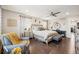 Bright main bedroom with hardwood floors, ceiling fan, sitting area, and neutral decor at 1669 Stable View Dr, Castle Pines, CO 80108