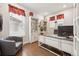Bright home office with a large desk, built-in bookshelves, and natural light at 1669 Stable View Dr, Castle Pines, CO 80108