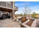 Inviting outdoor patio with comfortable seating and a view of the landscaped backyard at 1669 Stable View Dr, Castle Pines, CO 80108