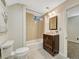 Clean bathroom features a shower-tub combo, vanity with sink, and neutral-colored tiles at 732 Poplar St, Denver, CO 80220