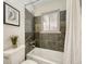Cozy bathroom with tiled tub and natural light at 732 Poplar St, Denver, CO 80220