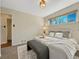 Bright bedroom features a large bed, neutral decor and window for natural light at 732 Poplar St, Denver, CO 80220