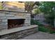 Outdoor stone fireplace with seating area, perfect for entertaining in a landscaped backyard at 732 Poplar St, Denver, CO 80220