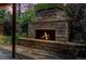 Outdoor stone fireplace with visible flames, creating a warm and inviting space in the yard at 732 Poplar St, Denver, CO 80220